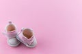 Pink baby shoes on a gentle pink background. The concept of the first steps, birthday, expectation, pregnancy, motherhood, Royalty Free Stock Photo