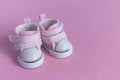 Pink baby shoes on a gentle pink background. The concept of the first steps, birthday, expectation, pregnancy, motherhood, Royalty Free Stock Photo