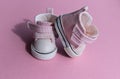 Pink baby shoes on a gentle pink background. The concept of the first steps, birthday, expectation, pregnancy, motherhood, Royalty Free Stock Photo