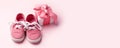 Pink baby shoes and gift present box, concept of first steps, birthday, expectation, pregnancy, maternity, motherhood, parenthood Royalty Free Stock Photo