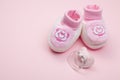 Pink baby shoes and pacifier Royalty Free Stock Photo