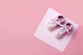 Pink baby shoes on pink background. Top view. Copy space. Ai generative Royalty Free Stock Photo