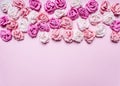 Pink background with colorful paper roses decorations Valentine's Day border ,place text top view close up