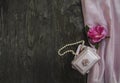 Pink background with gift box and pearl beads and a rose, mother day, symbols of love Royalty Free Stock Photo