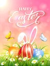 Pink background with rabbit and three Easter eggs in grass Royalty Free Stock Photo