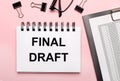 On a pink background, reports, black paper clips, glasses and a white notebook with the text FINAL DRAFT Royalty Free Stock Photo