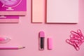 On a pink background, school accessories and a pen, colored pencils, a pair of compasses, a pair of compasses, a pair of