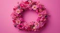 Pink background showcases a wreath of different small flowers, providing space for personalized text