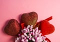 Pink background. St. Valentine`s Day. Red hearts in spangles with bows. Love. Bouquet of flowers. The place for an inscription. Royalty Free Stock Photo