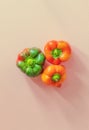 On a pink background from the upper angle there are three peppers of the same shape Royalty Free Stock Photo