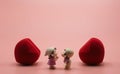 The pink background wallpaper has two red heart in the middle girl and boy doll toy romantic happy lovers kissing in 14 fourteen