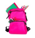 Pink backpack full of school supplies isolated on a white background