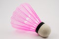 Pink badminton shuttlecock on a white