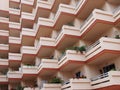 pink balconies on large modern apartment building with house plants Royalty Free Stock Photo