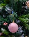 Pink ball with snowflakes and frost on a Christmas tree, vertical photo postcard. Winter seasonal holiday, christmas decoration, Royalty Free Stock Photo