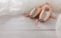 Pink ballet pointe shoes and tutu on white wood background Royalty Free Stock Photo