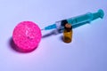 Pink balloon, syringe and small vial. Concept of vaccination, anti-virus. Close-up. Selective focus