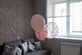 Pink balloons in the interior of a dark gray room of a teenage girl Royalty Free Stock Photo