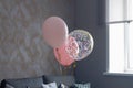 Pink balloons in the interior of a dark gray room of a teenage girl Royalty Free Stock Photo