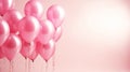 Pink balloons party background with copy space on the right. Group of pastel party balloons on soft background. Concept