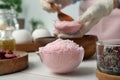 Pink bath bomb mixture in mold and blurred view of woman on background Royalty Free Stock Photo