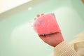 pink bath bomb on woman hand, relaxation time Royalty Free Stock Photo