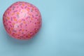 Pink beach ball on light blue background, top view. Space for text Royalty Free Stock Photo
