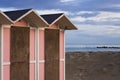 Pink beach cabins in the bathhouse on the sand with Mediterranean sea in background Italy, Europe
