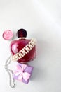 Pink beautiful glass transparent bottle of female perfume decorated with white pearls and a candle in the form of a rose blue smal Royalty Free Stock Photo