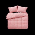 Pink Bedding Set With Two Pillows and a Comforter on a White Background in a Simple Arrangement Royalty Free Stock Photo