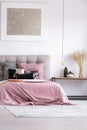 Pink bedsheets on king-size bed