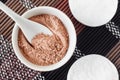 Pink bentonite clay powder in the small white bowl and cotton pads. Clay texture close up. Diy facial or hair mask, dry shampoo Royalty Free Stock Photo