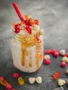 Pink berry milkshake with whipped cream, dripping sauce and candy`s Royalty Free Stock Photo