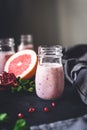 Pink berry smoothie with pomegranate, acai and grapefruit in jar