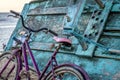 Pink bicycle leaned on turquoise fishermen boat Royalty Free Stock Photo