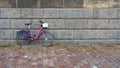 Pink bicycle parked on a wall on the banks of the Vltava River in Prague Royalty Free Stock Photo