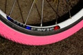 Pink bicycle rubber tire. Thin racing bike wheel closeup Royalty Free Stock Photo