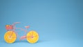 Pink bike with sliced orange wheels, healthy lifestyle concept with blue pastel background copy space Royalty Free Stock Photo