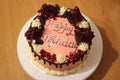 Pink birthday cake decorated with pomegranate