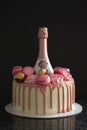 Pink birthday cake over a black background