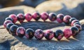 A pink and black bracelet made of beads Royalty Free Stock Photo