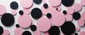 Pink and black circles creating abstract geometric background.
