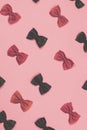 Pink and black pasta farfalle lies diagonally