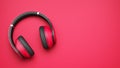 Pink and black wireless headphones isolated on pink