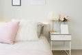 Pink and blue blanket with creative pillows on bed in colorful kids room Royalty Free Stock Photo