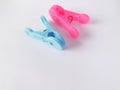 Pink and blue clothing clips on the white background.