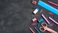 Pink and blue color school stationery on black board background. Flat lay, top view, copy space. Back to school concept Royalty Free Stock Photo