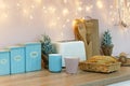 Pink and blue cup and fresh baked bread on countertop. Pink white and blue kitchen interior on holidays, christmas light and Royalty Free Stock Photo