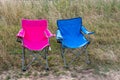 Pink and blue folding camping chairs