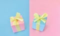 Pink and blue gift boxes on half pink and half blue background.